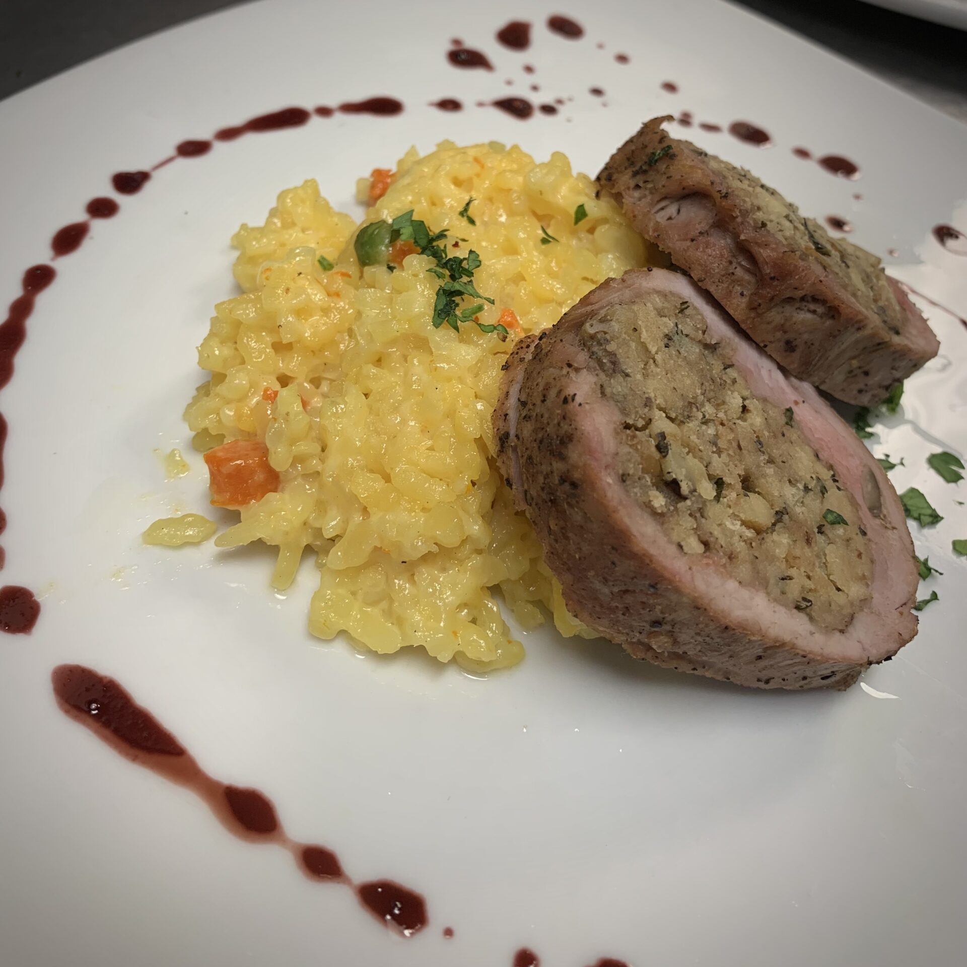 Two stuffed meat slices on top of sticky yellow rice