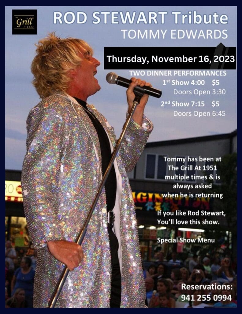 A person in a silver sequined jacket holding a microphone.