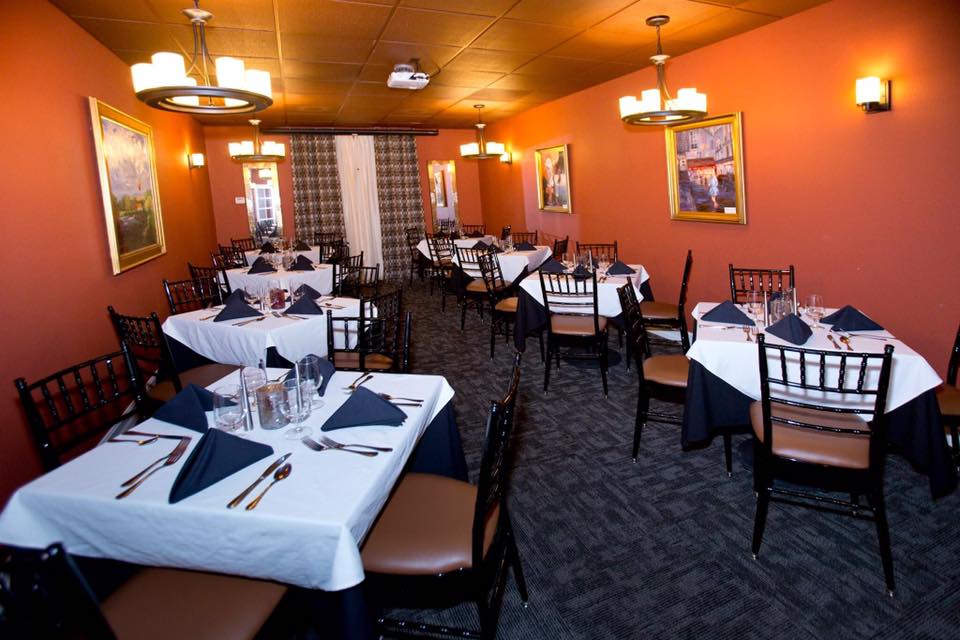 Elegant small restaurant dining room with set tables