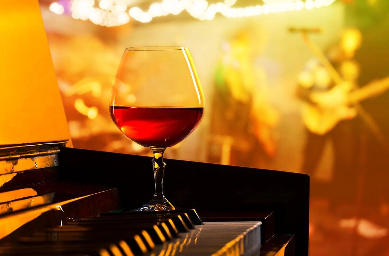 Wine glass on piano at live music venue